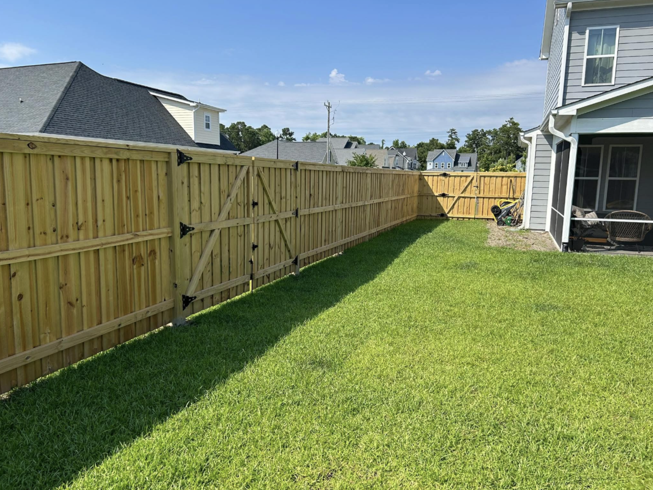Wood board-on-board privacy fence with decorative trim cap in Hampstead
